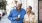 older couple walks down city sidewalk while holding ice cream cones